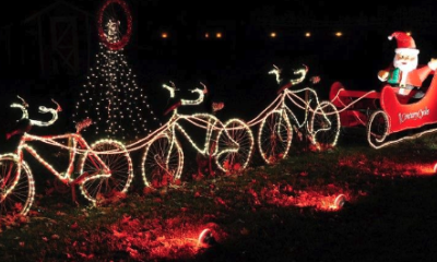 Santa in sleigh with lighted bicycles instead of reindeer